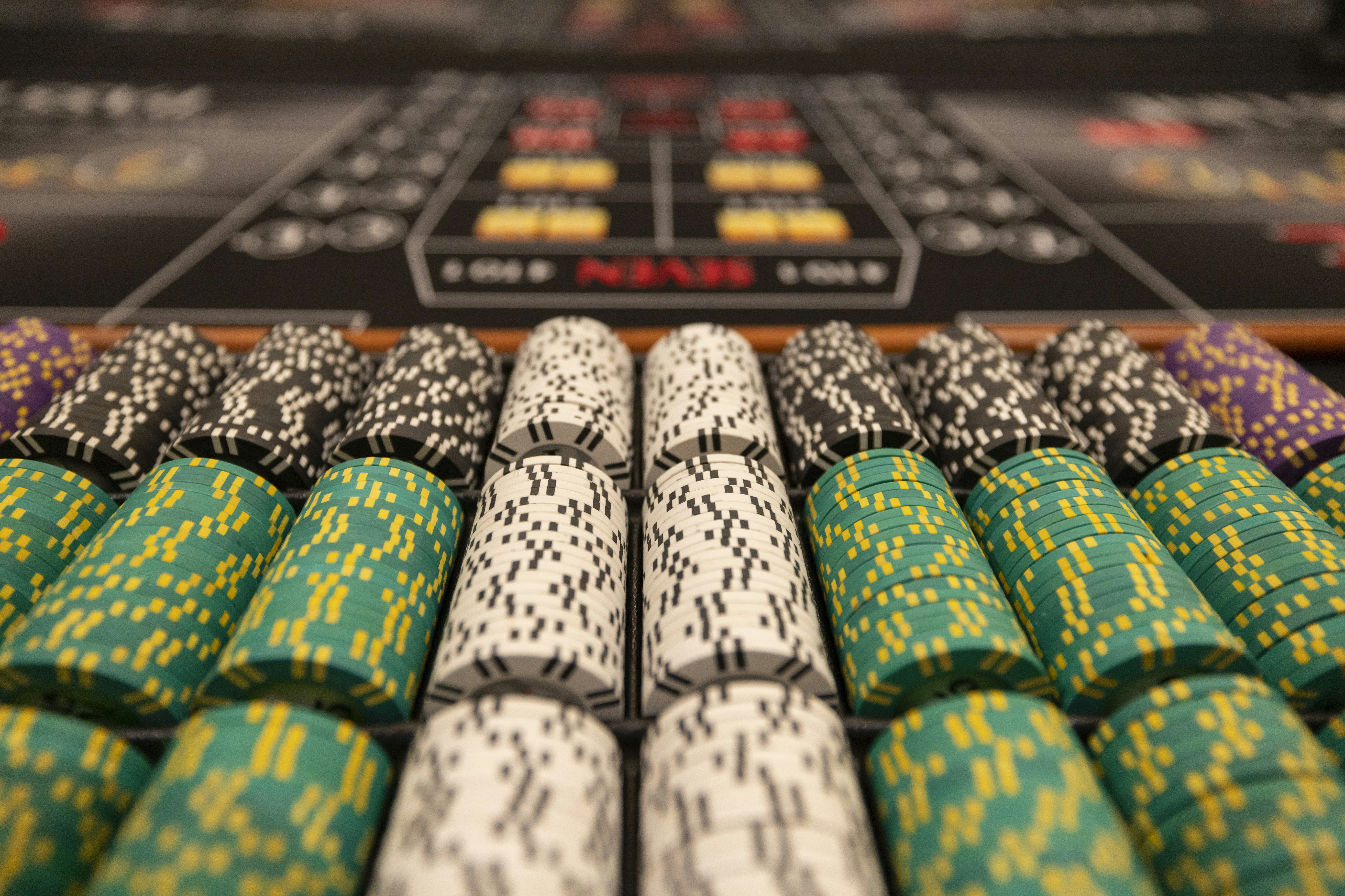 a close up of many different colored poker chips